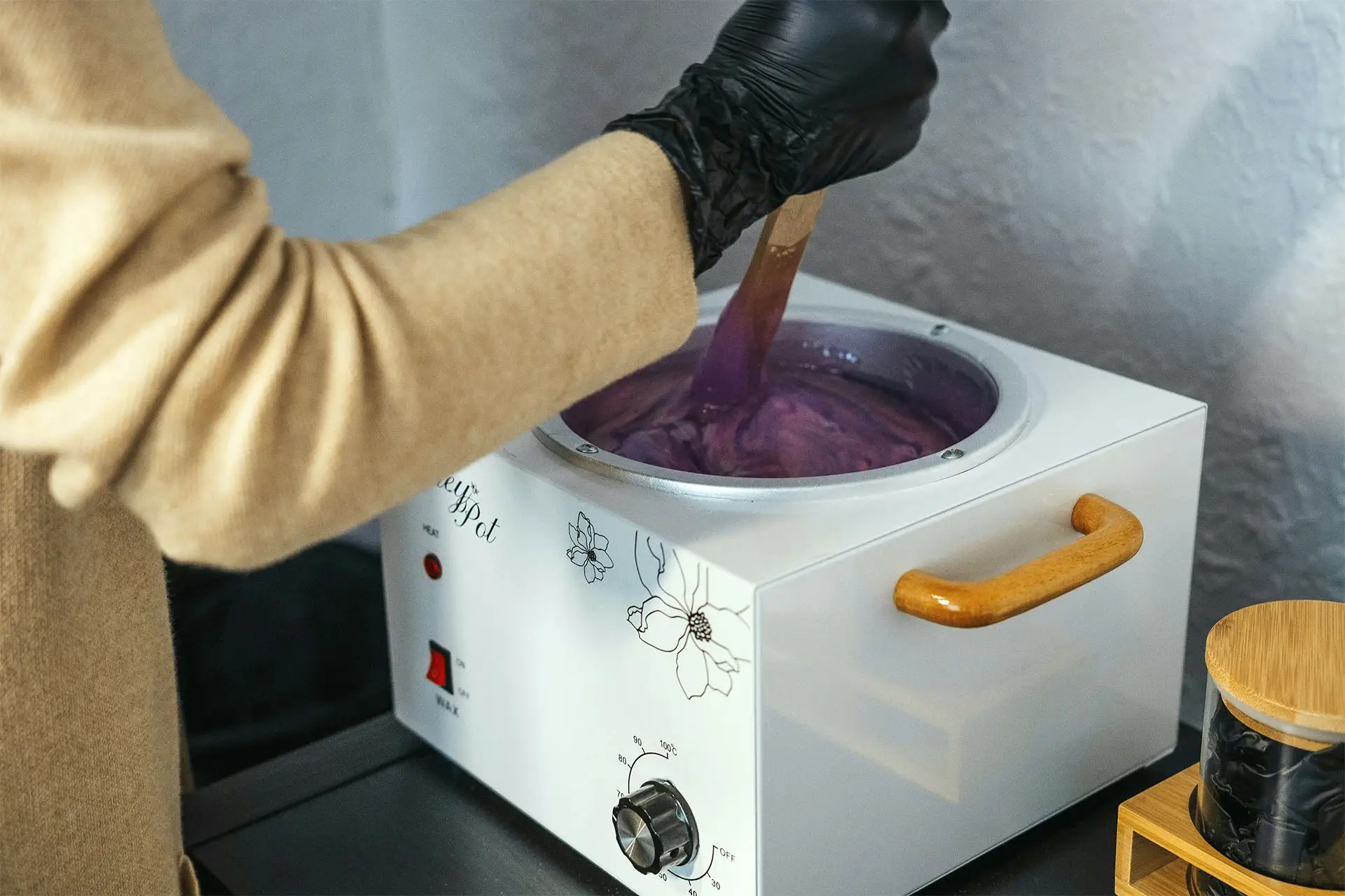 Belleza Center team member mixing natural ingredients in a machine to create facial treatments